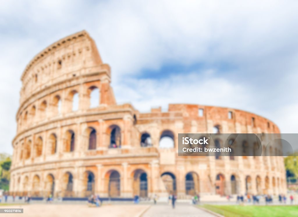 Defocused background of the Flavian Amphitheatre, aka Colosseum in Rome Defocused background of the Flavian Amphitheatre, aka Colosseum in Rome. Intentionally blurred post production for bokeh effect Amphitheater Stock Photo