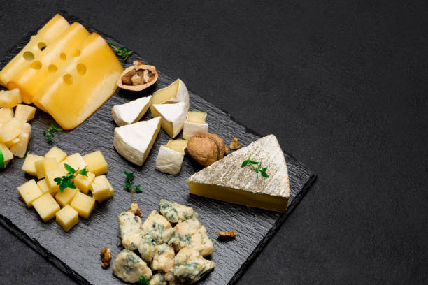istock various types of cheese - brie, camembert, roquefort and cheddar on concrete 950275284