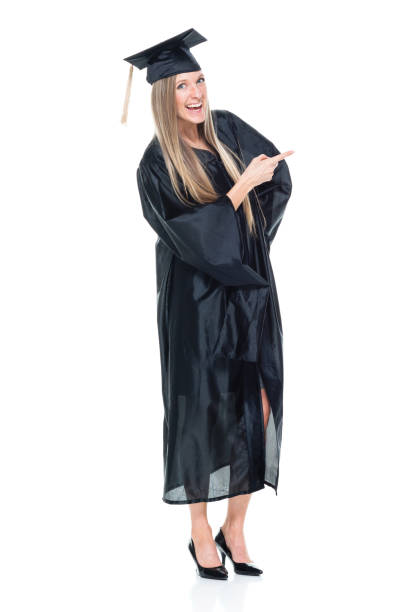 istock Female student graduating and is pointing 950275470