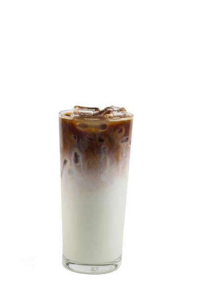 Isolate Iced coffee long glass on white background. Iced Caramel macchiato, double layer of Espresso shot coffee and fresh milk bellow.You can drinks this by regular or blend it by stir, it make your feels different.