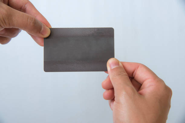 istock Hand holding business black card on white background. 950283878