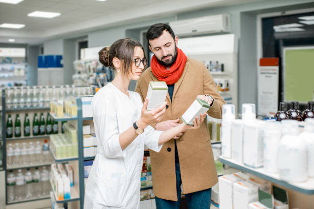 istock Pharmacist with client in the pharmacy store 950292474
