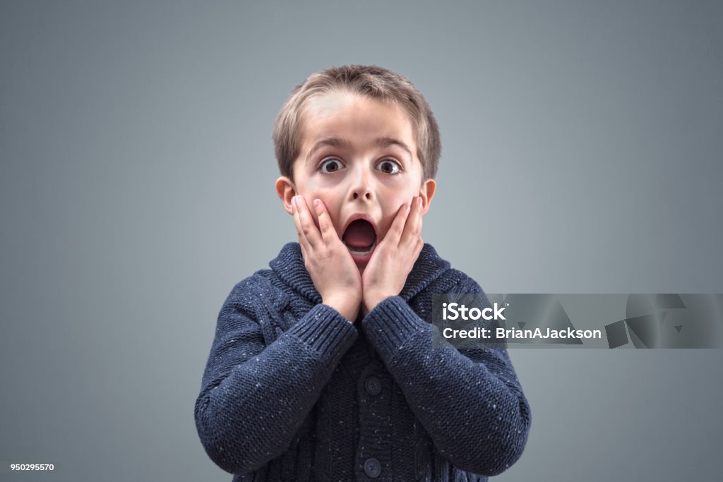 Shocked and surprised child Shocked and surprised boy with copy space concept for amazement, astonishment, making a mistake, stunned and speechless or back to school Child Stock Photo