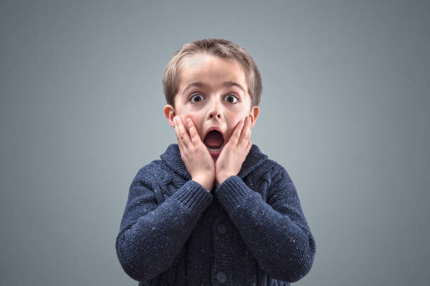 Shocked and surprised child Shocked and surprised boy with copy space concept for amazement, astonishment, making a mistake, stunned and speechless or back to school mouth open human face shouting screaming stock pictures, royalty-free photos & images