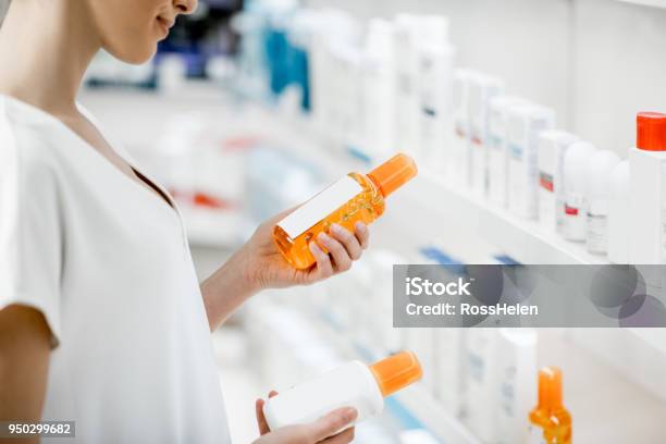 Taking Sunscreen Lotion At The Pharmacy Stock Photo - Download Image Now - Suntan Lotion, Skin Care, Buying