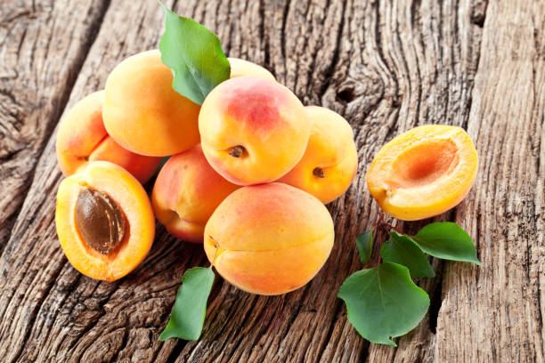 istock Ripe apricots and apricot leaves. 950300836