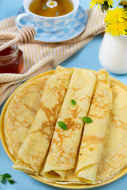istock Stack of thin pancakes crepes with honey and camomile tea 950301648