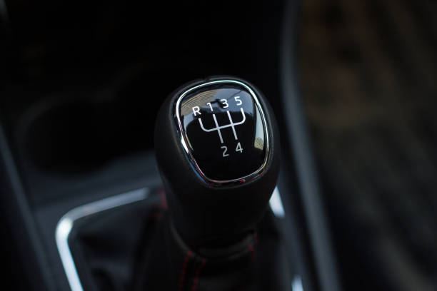 istock manual transmission gear shift, on dark backgroun. 950306272