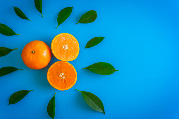 istock Cut fruit design of orange with desktop on plates blue background. topview or flat lay fruit. 950306562