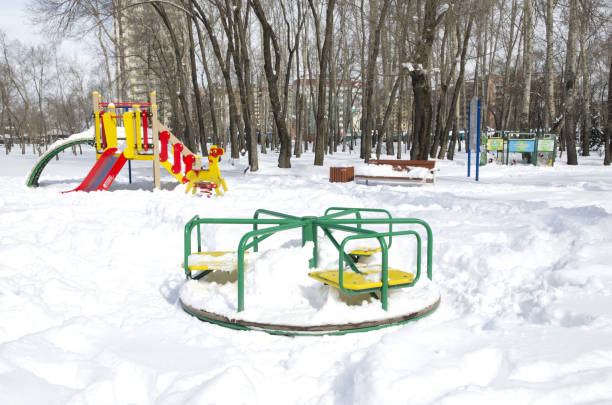 istock children's park after an unexpected snowfall in the spring. Snow fell a lot, it is very deep. Russia. Siberia. 04/01/2018 950309854
