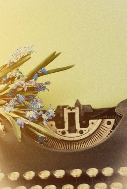 istock Old antique black vintage typewriter with blue romantic spring flowers. 950313588