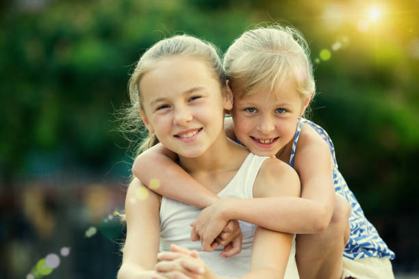 istock Two smiling little girls embracing 950317794