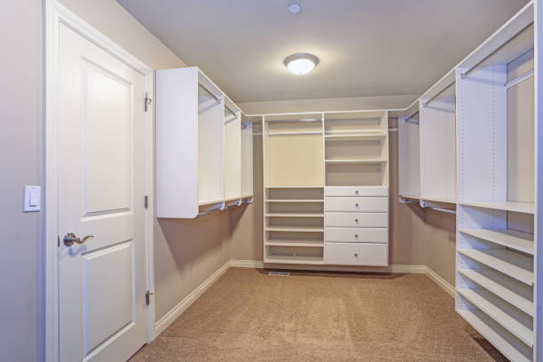 istock Large walk-in closet with white shelves, drawers 950318458