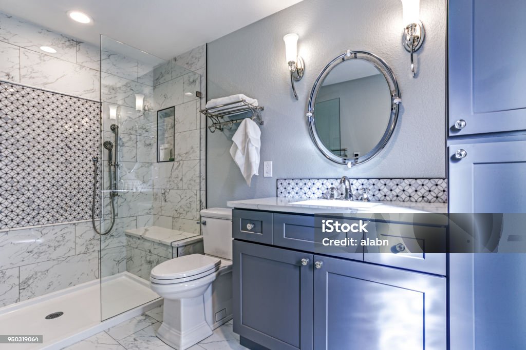 New blue bathroom design with Marble shower Surround Luxury bathroom design with Marble shower Surround and mosaic accent tiles. Bathroom Stock Photo