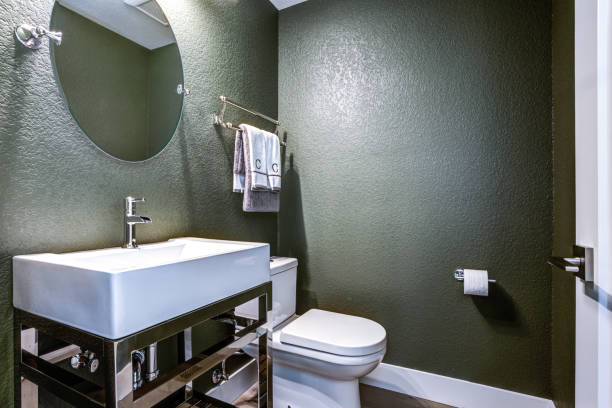 Dark Gray powder room with chrome washstand Dark Gray powder room features chrome washstand with white sink next to toilet. powder room stock pictures, royalty-free photos & images