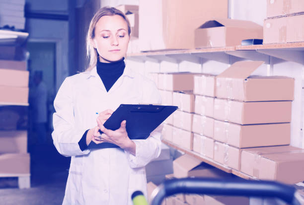 istock female worker transporting cart cardboard  cases in storage 950322774
