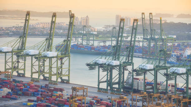 istock Container Cargo freight ship with working crane bridge in shipyard in singapore 950327194