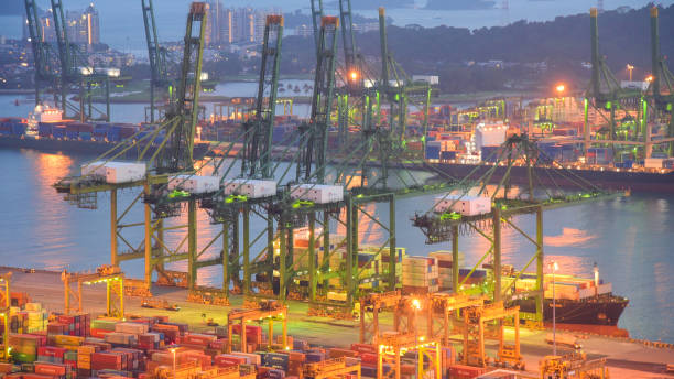 istock Container Cargo freight ship with working crane bridge in shipyard in singapore 950327624