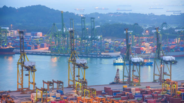 istock Container Cargo freight ship with working crane bridge in shipyard in singapore 950336200