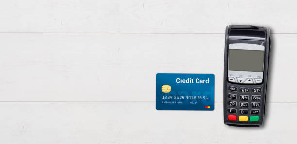 istock Payment terminal and credit card on wooden background 950336514
