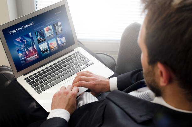 istock Man using laptop for watching movie on VOD service. 950336702