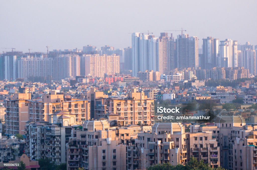 Cityscape in an indian city with concrete buildings and skyscrap Cityscape in Noida, gurgaon, jaipur, delhi, lucknow, mumbai, bangalore, hyderabad showing small houses sky scrapers and other infrastructure options India Stock Photo