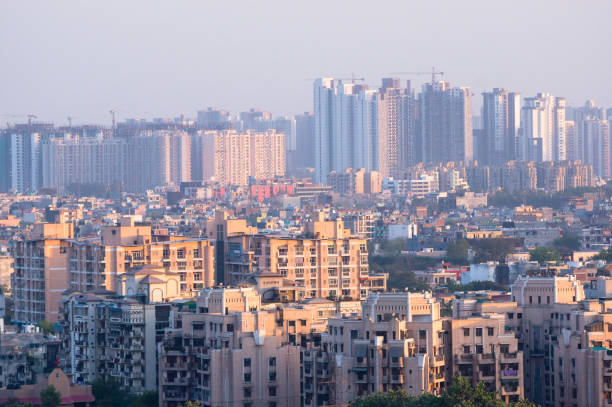 Cityscape in an indian city with concrete buildings and skyscrap Cityscape in Noida, gurgaon, jaipur, delhi, lucknow, mumbai, bangalore, hyderabad showing small houses sky scrapers and other infrastructure options hyderabad india photos stock pictures, royalty-free photos & images