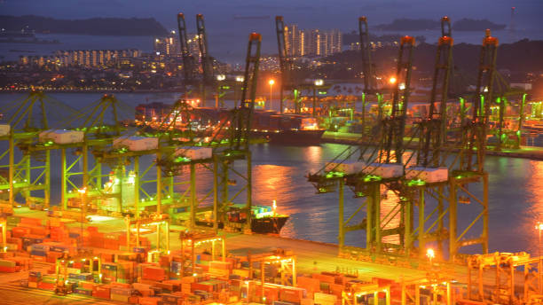 istock Container Cargo freight ship with working crane bridge in shipyard in singapore 950336946