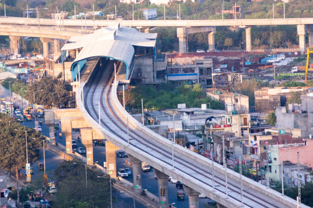 Under construction metro station in the middle of the city Under construction metro station on the side of a busy street and in the middle of an indian city like delhi, gurgaon, jaipur, mumbai, lucknow, hyderabad. This is one of the most used transport options hyderabad india stock pictures, royalty-free photos & images