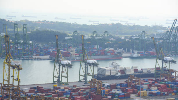 istock Container Cargo freight ship with working crane bridge in shipyard in singapore 950337586
