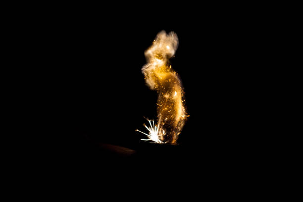 istock Close up view of real sparking light from lighter in dark black background 950338272