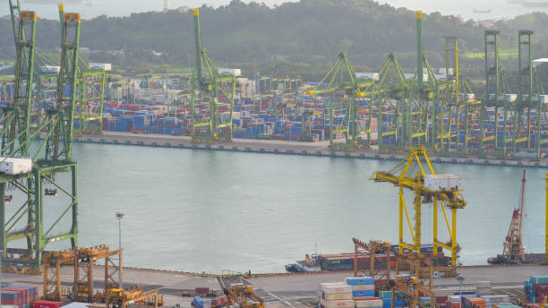 istock Container Cargo freight ship with working crane bridge in shipyard in singapore 950338774