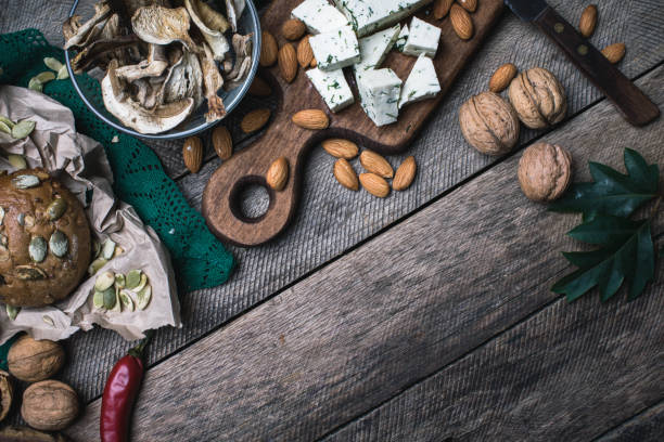 istock Autumn harvest nuts mushrooms cheese and bread buns in rustic style 950341232