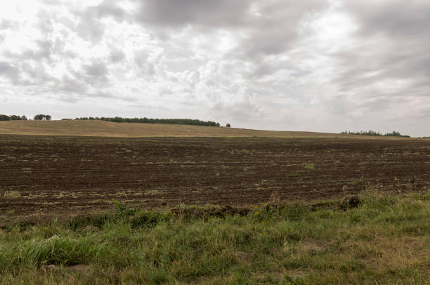 istock Heavy big grey clouds in the cold autumn sky over fields, forests and mountains. Before storm 950341412