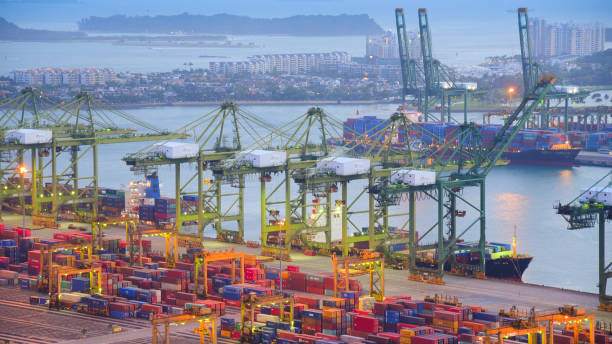 istock Container Cargo freight ship with working crane bridge in shipyard in singapore 950345058