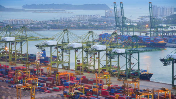 istock Container Cargo freight ship with working crane bridge in shipyard in singapore 950345802