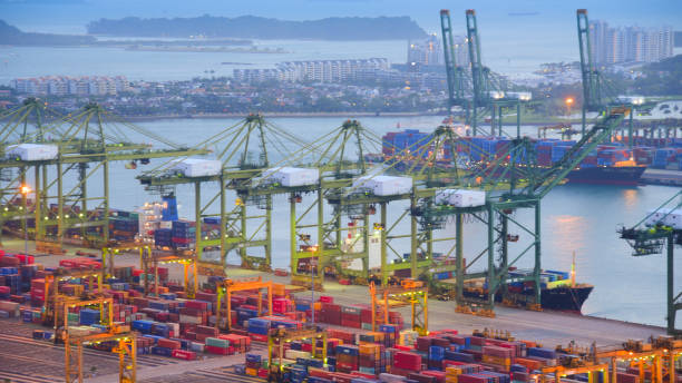 istock Container Cargo freight ship with working crane bridge in shipyard in singapore 950345838