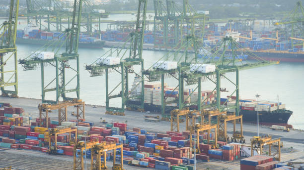 istock Container Cargo freight ship with working crane bridge in shipyard in singapore 950345922
