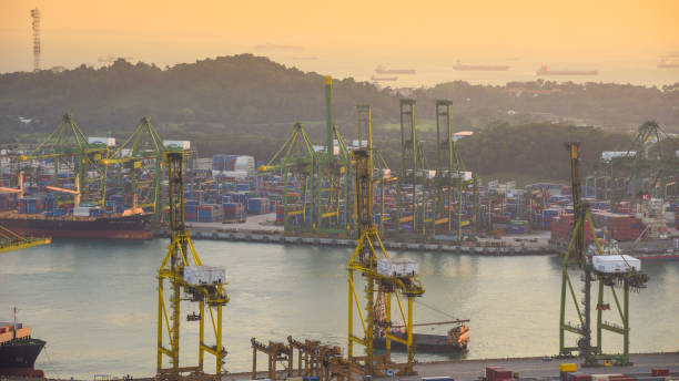 istock Container Cargo freight ship with working crane bridge in shipyard in singapore 950345994