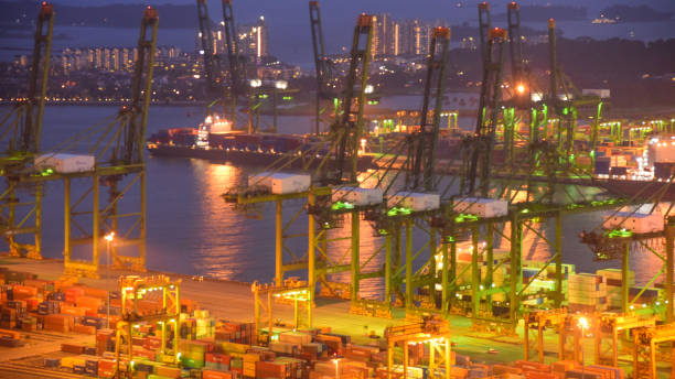 istock Container Cargo freight ship with working crane bridge in shipyard in singapore 950346116