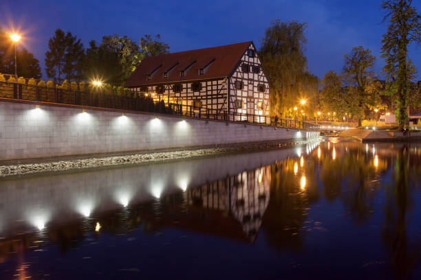 City of Bydgoszcz in Poland, White Granary on Mill Island at night, river Brda waterfront.
