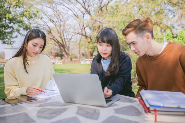 istock Group Students Smile and have fun It also helps to share ideas in the work and project. And also review the book before the exam in the garden. 950357030