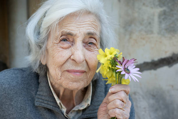 istock Serene Senior Woman and Flowers 950359778