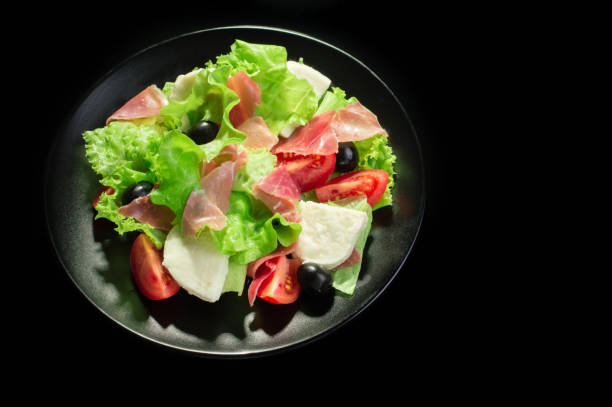 istock Fresh tasty salad on a glossy black background 950363868