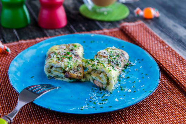 istock Omelette with greens on a blue plate side view 950364394
