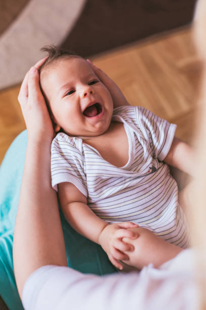 istock Mother holding her smiling newborn son 950367390