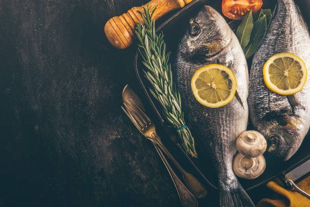 istock Fish with spices and vegetables in pan 950367636