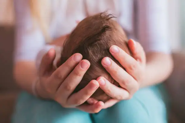 Photo of Mother holding newborn baby boy