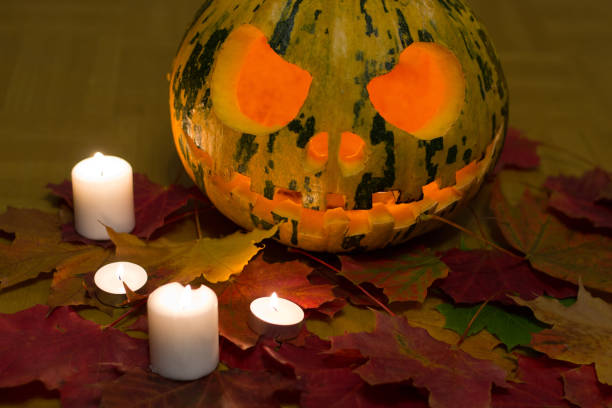 istock Halloween pumpkin with leaves and burning candles 950371092