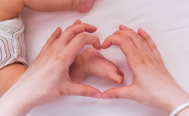 istock Baby feet in heart shape 950371280